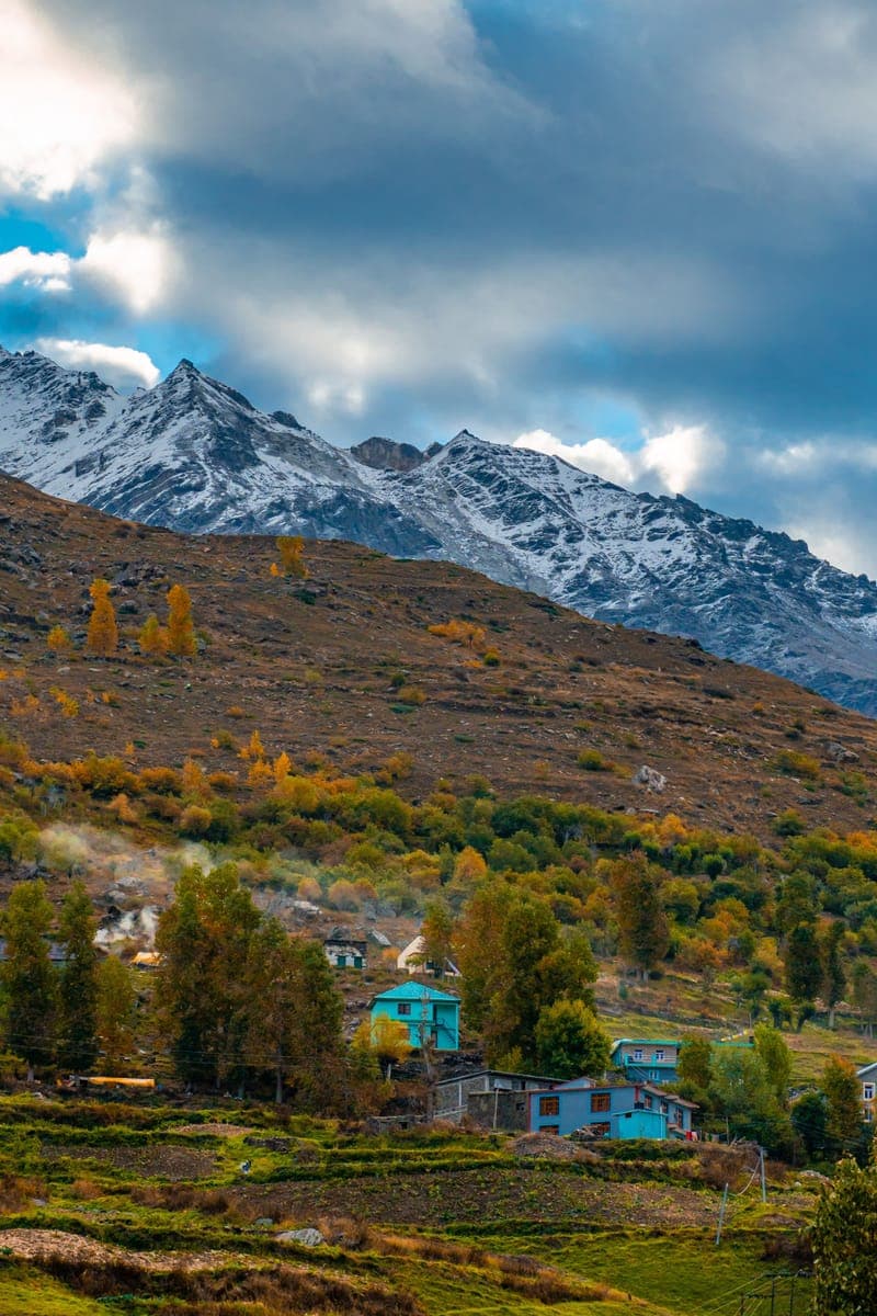 Snow-covered peaks above a Himalayan village