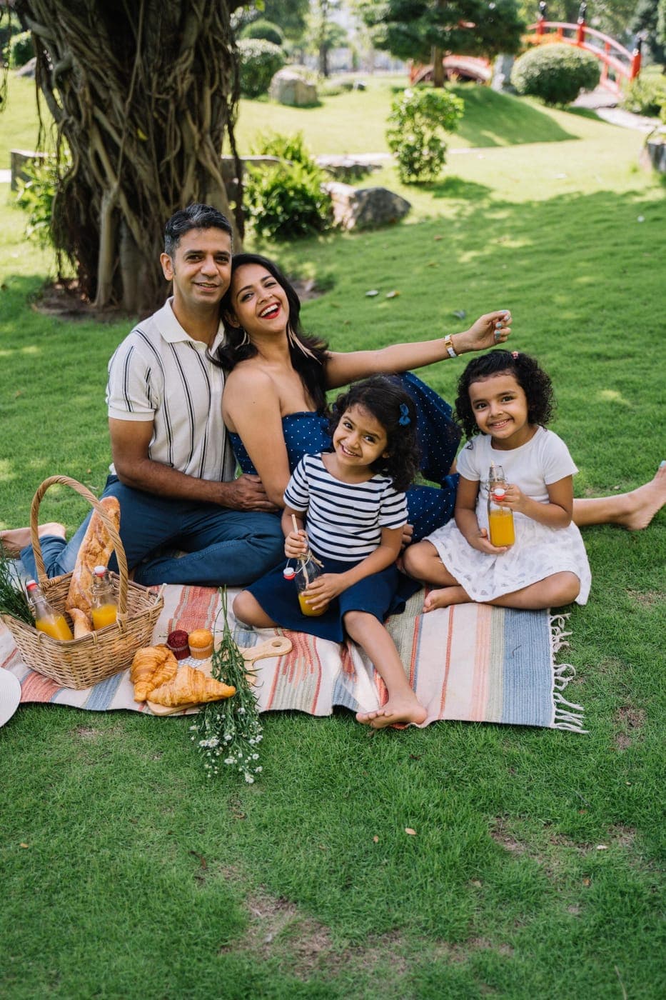 Family enjoying a picnic together on a lawn